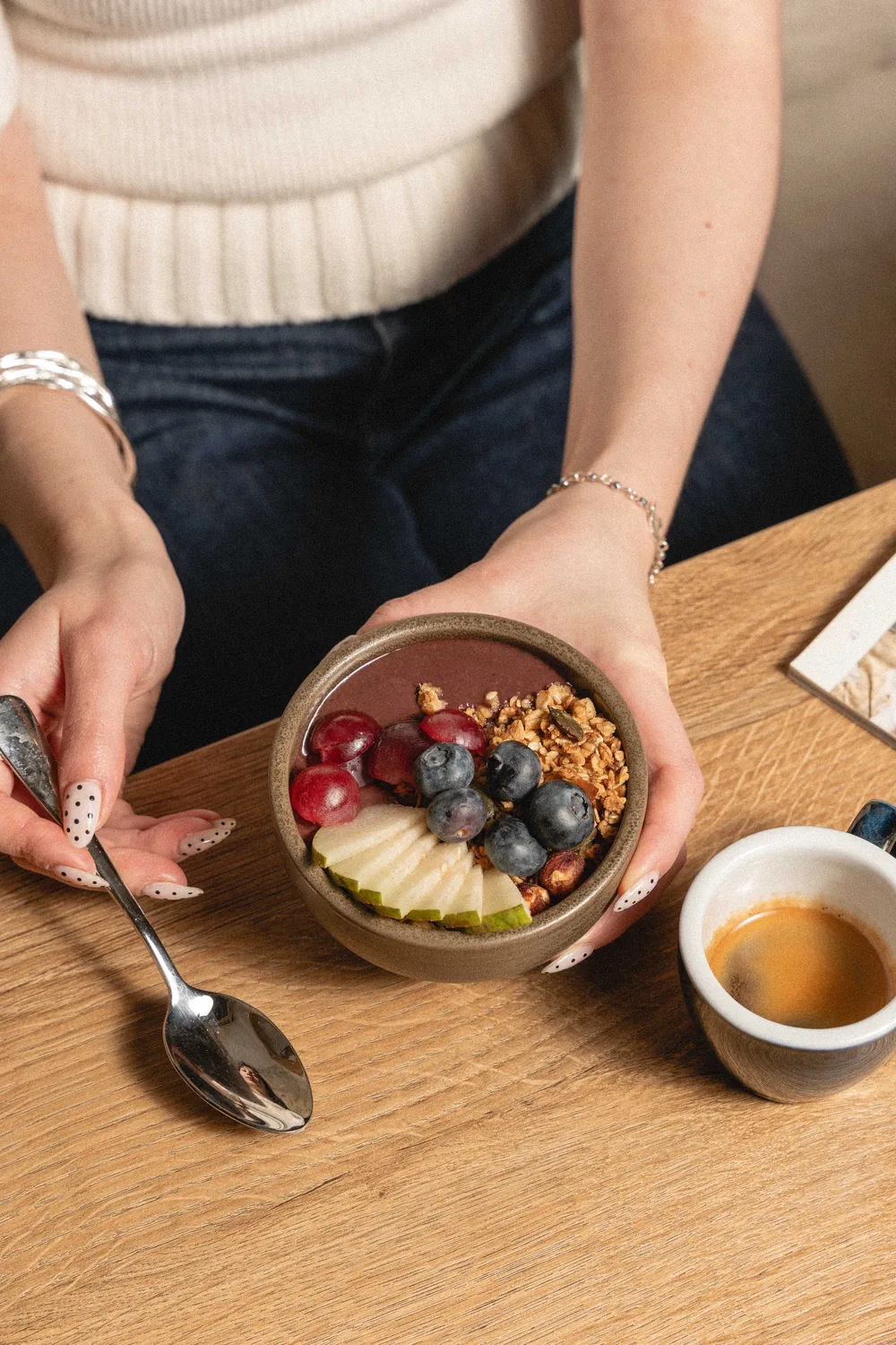 Generous breakfast bowl with fresh fruit, granola and pear, served at Marlette Abbesses with coffee