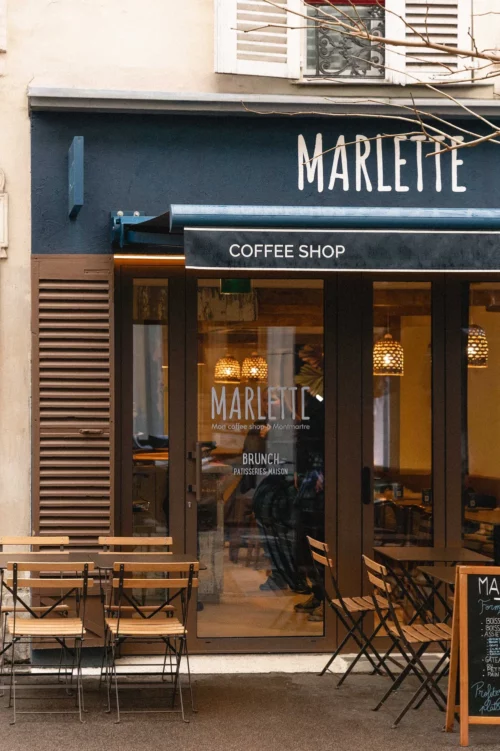 Elegant facade of Marlette coffee shop in Montmartre, rue des Abbesses, with welcoming terrace and homemade brunch