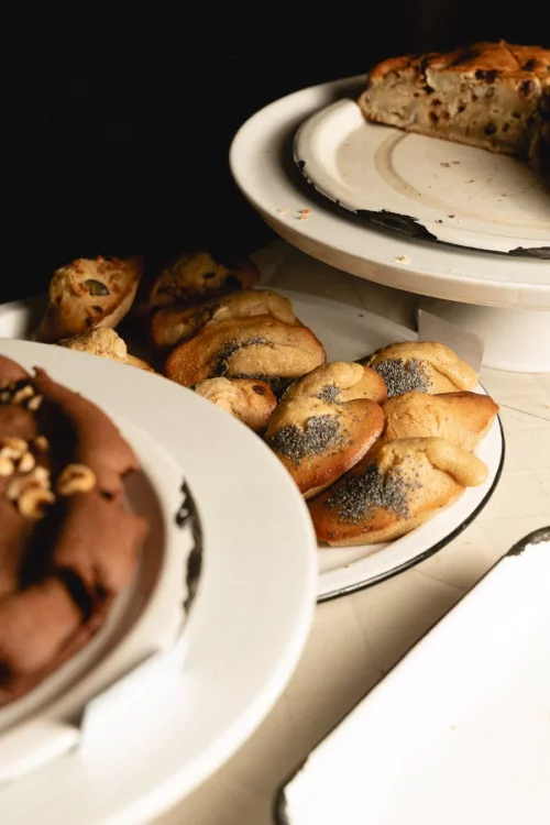 Plates of homemade organic pastries: poppy seed madeleine and fresh butter tartine at Marlette Pigalle