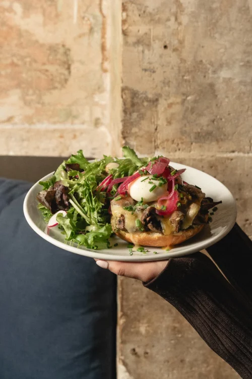 Generous Marlette brunch plate: grilled tartine topped with poached egg, beetroot and fresh salad