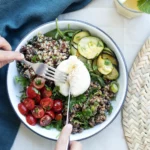 Assiette généreuse de salade fraîche avec quinoa, chèvre frais, tomates et concombre - déjeuner gourmand