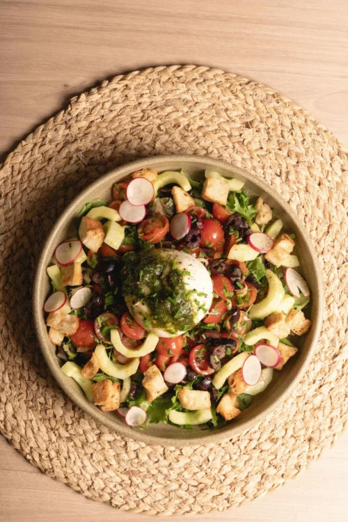 Generous salad with poached egg, avocado, fresh vegetables and tasty croutons at Marlette Abbesses